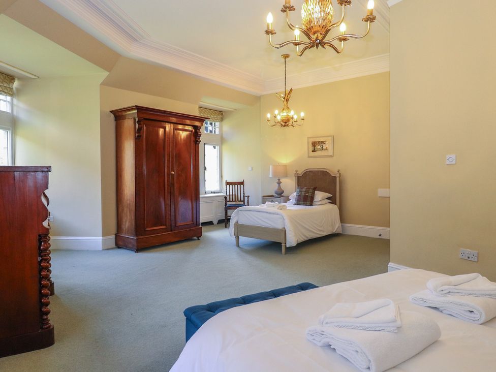 A bedroom with beds and a wardrobe at Bynack - Mar Lodge Estate, Braemar