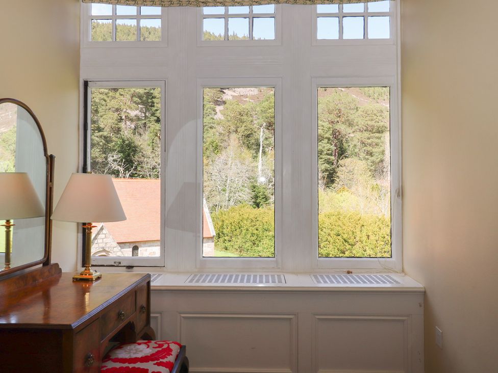 A study with a desk and lamp at Bynack - Mar Lodge Estate in Braemar