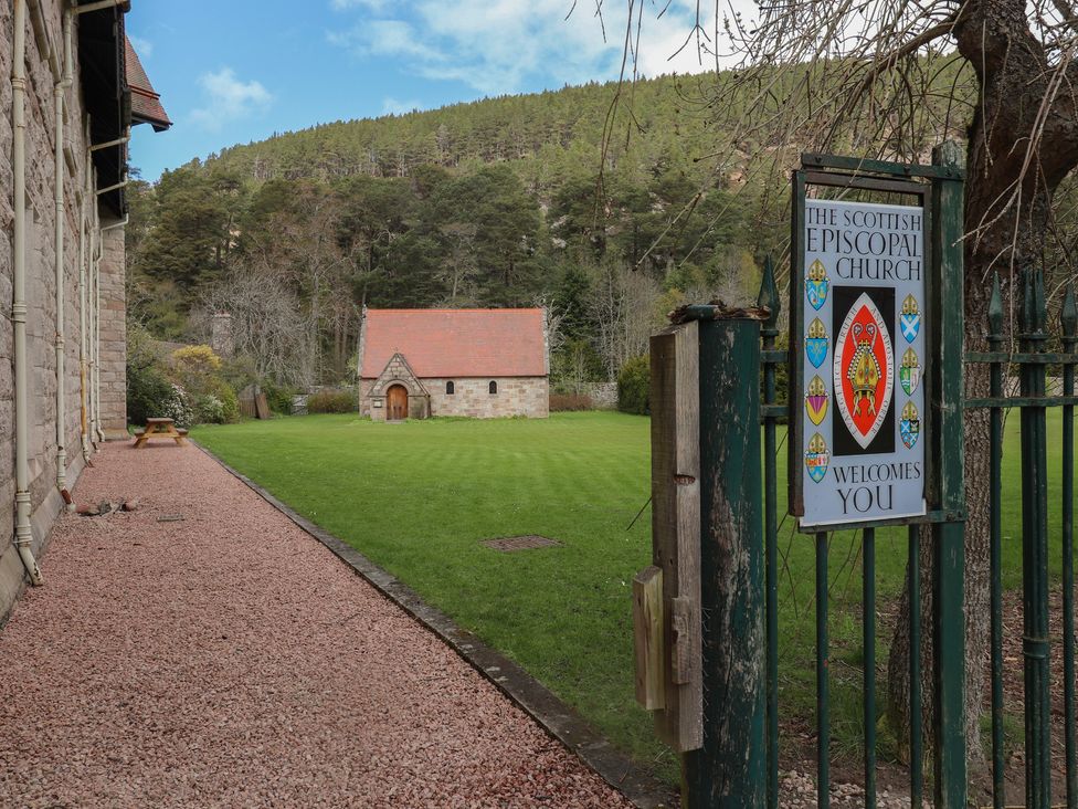 An outdoor area with a church and sign at Derry - Mar Lodge Estate in Braemar