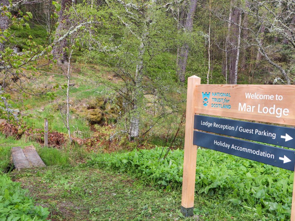 A sign for Mar Lodge with directions to guest parking and holiday accommodation at Macdui - Mar Lodge Estate in Braemar