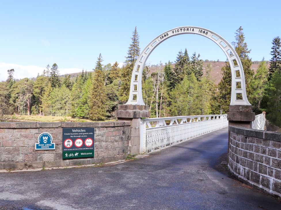 A bridge entrance with a sign at Mar Lodge Estate in Braemar
