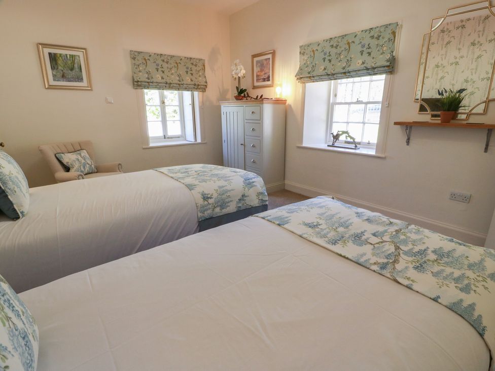 A bedroom with two beds and a dresser at Ardlochan Lodge - Culzean Castle in Maybole
