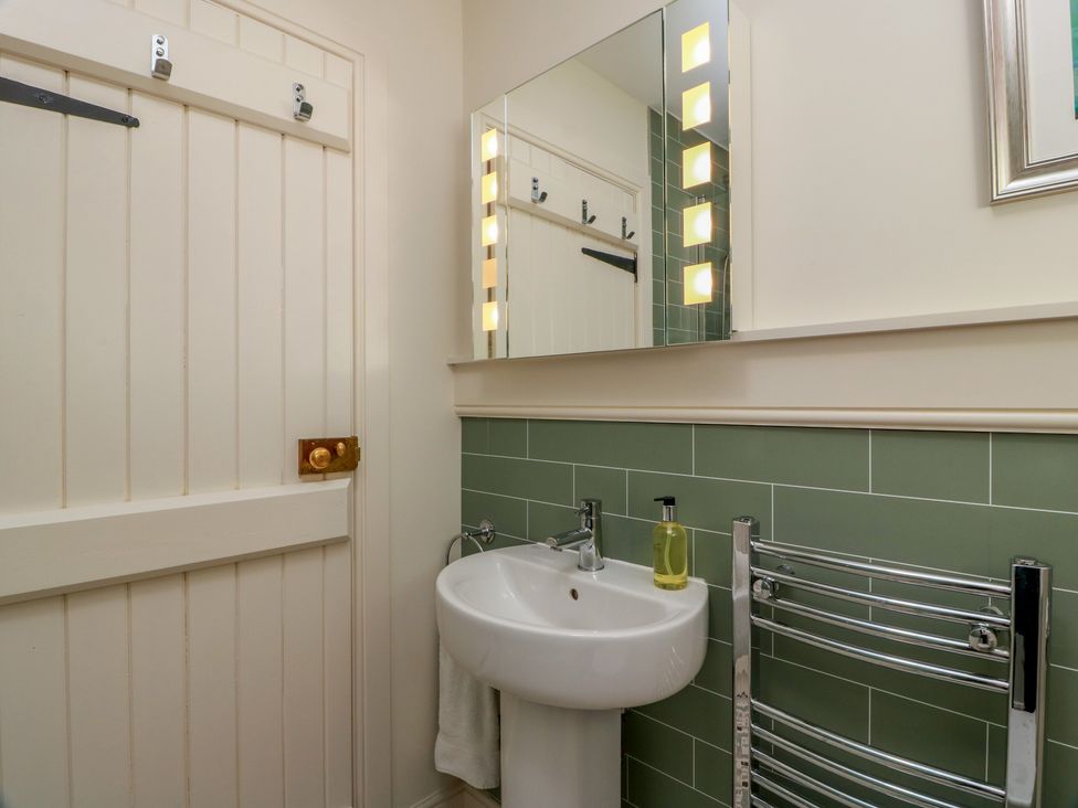 A bathroom with a sink and mirror at Ardlochan Lodge - Culzean Castle Maybole