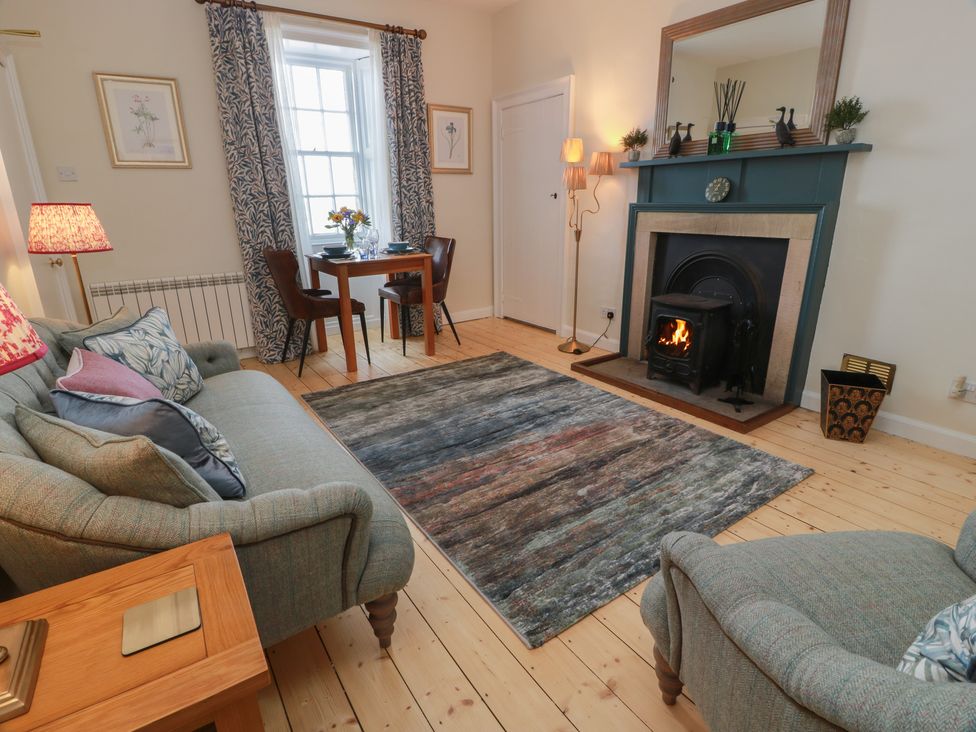 A living room with a fireplace and furniture at North Segganwell - Culzean Castle Maybole
