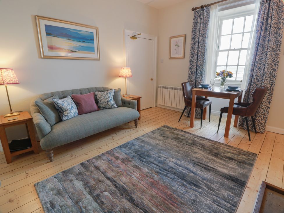 A living room with a sofa and a dining table at North Segganwell - Culzean Castle in Maybole