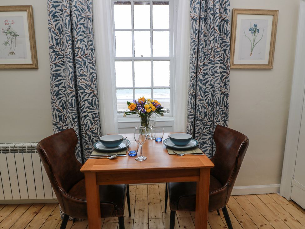 A dining room with a table set for two at North Segganwell - Culzean Castle Maybole
