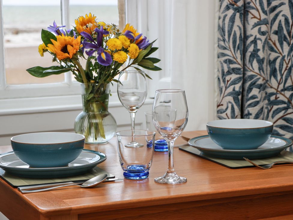 A dining room table set with dinnerware and a flower vase at North Segganwell - Culzean Castle, Maybole