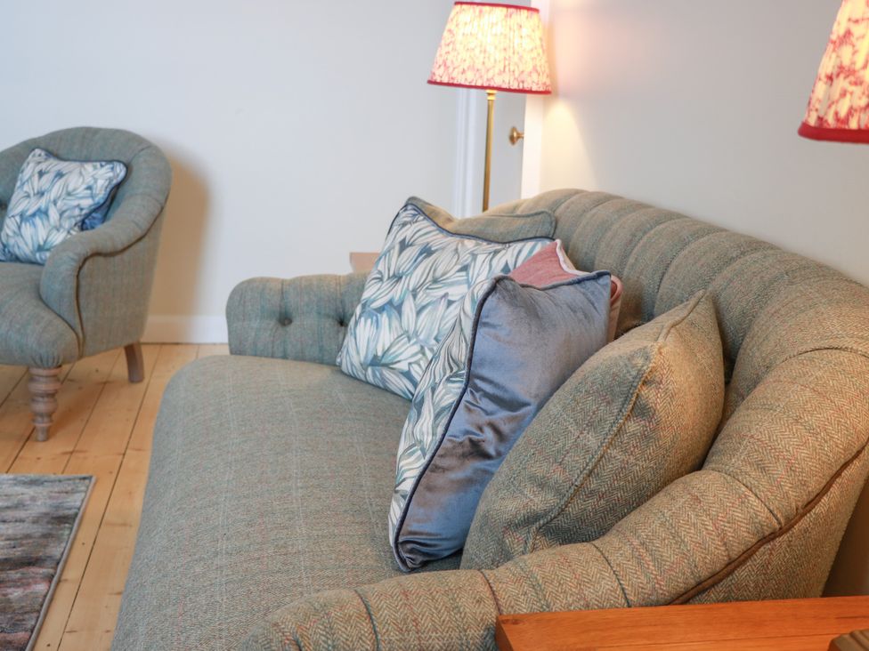 A sofa with cushions and an armchair at North Segganwell - Culzean Castle Maybole
