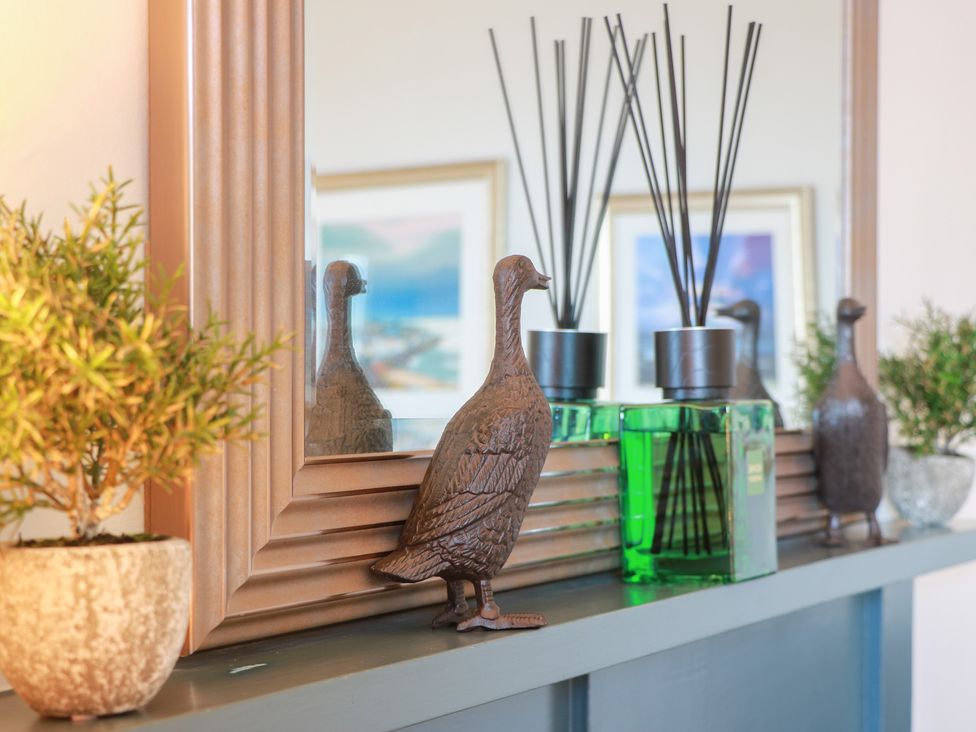 A living room mantel with a mirror and decorative items at North Segganwell - Culzean Castle Maybole