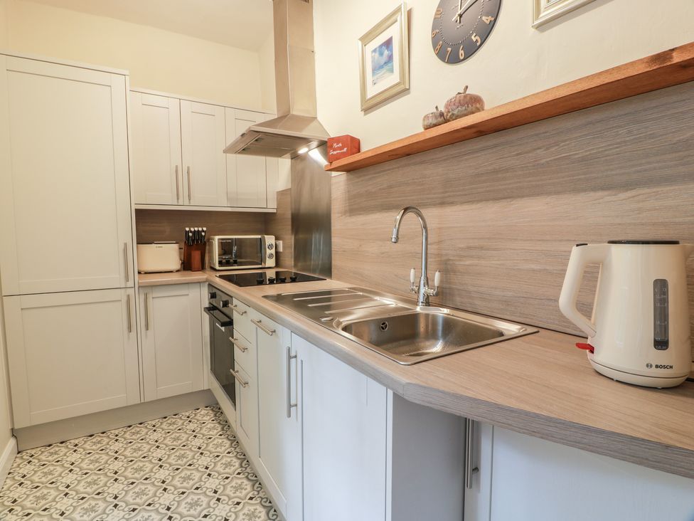 A kitchen with cabinets and appliances at North Segganwell - Culzean Castle, Maybole
