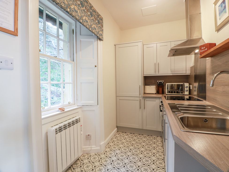A kitchen with cabinets, sink, and appliances at North Segganwell - Culzean Castle Maybole