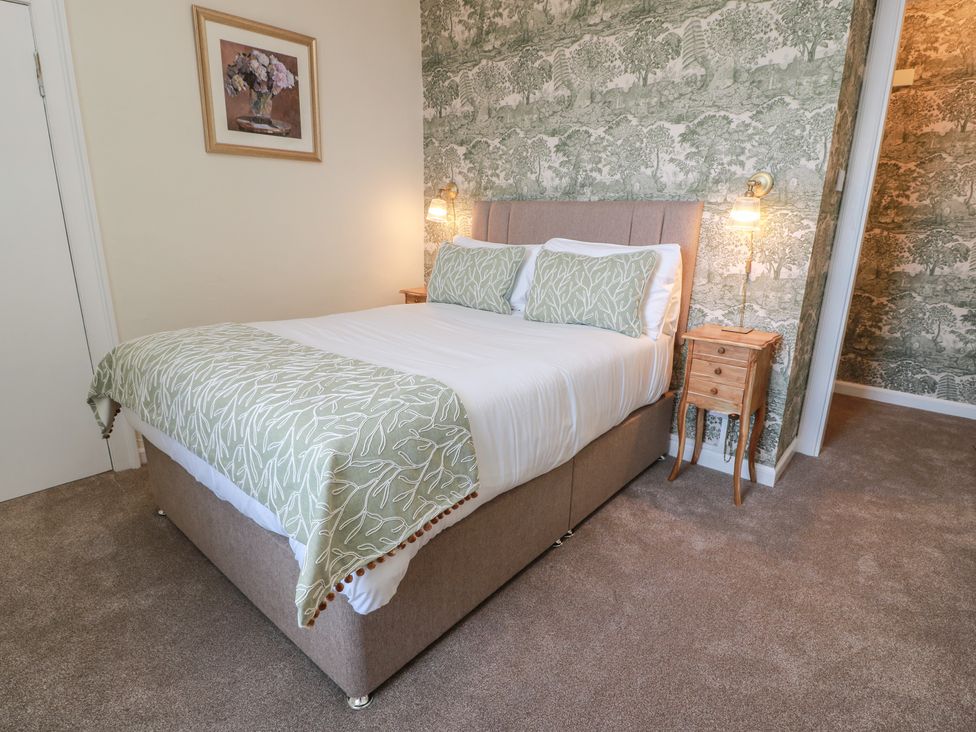 A bedroom with a bed and bedside table at North Segganwell - Culzean Castle, Maybole