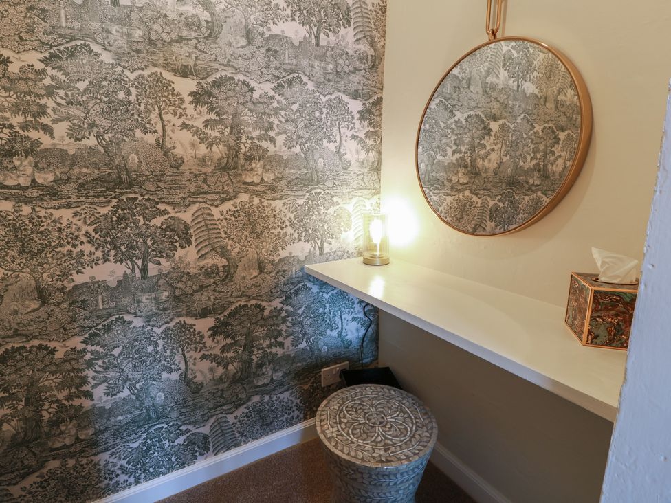 A bathroom with a mirror and lamp at North Segganwell - Culzean Castle, Maybole