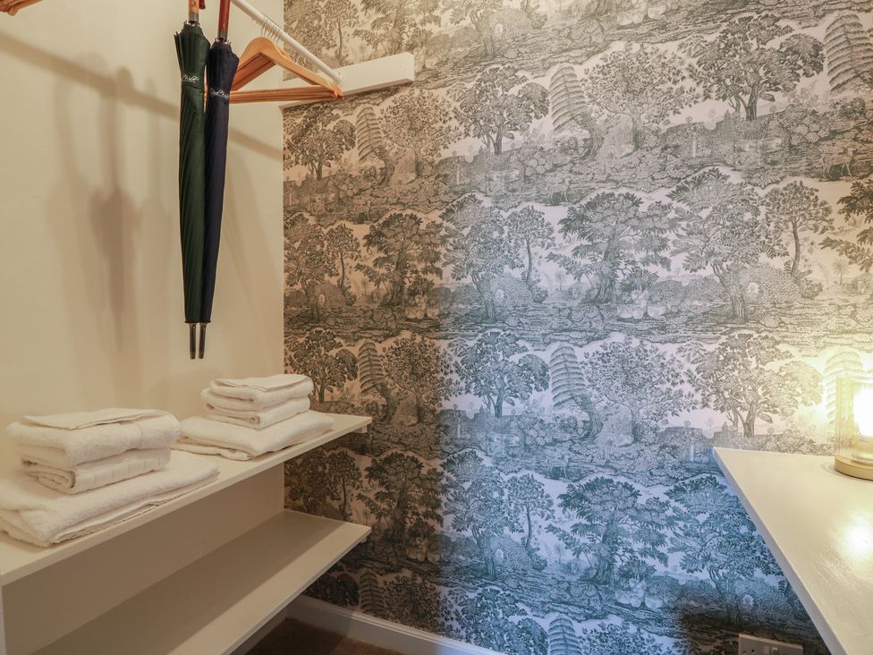 A closet with umbrellas and stacked towels at North Segganwell - Culzean Castle, Maybole