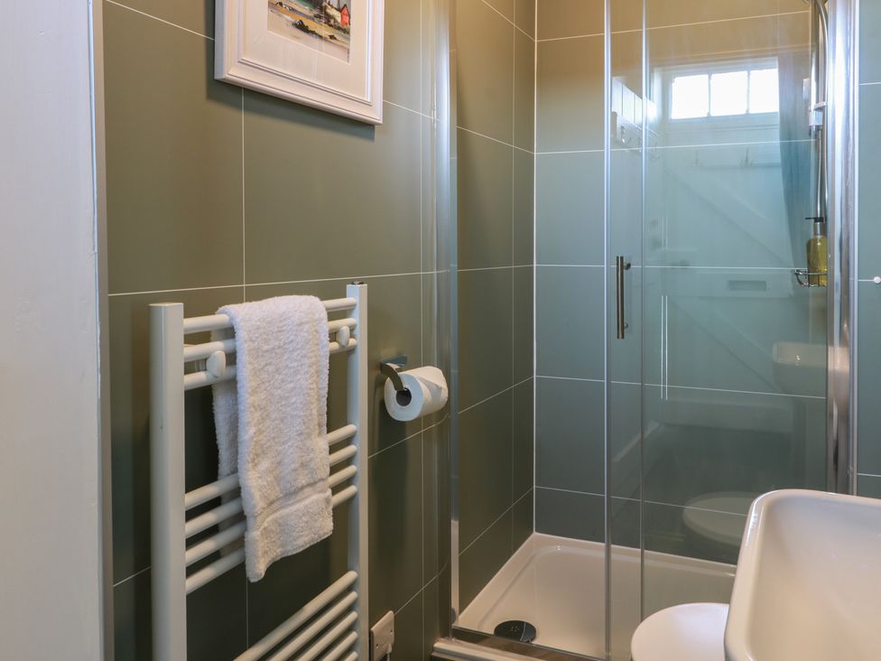 A bathroom with a shower, towel rail, and sink at North Segganwell - Culzean Castle, Maybole