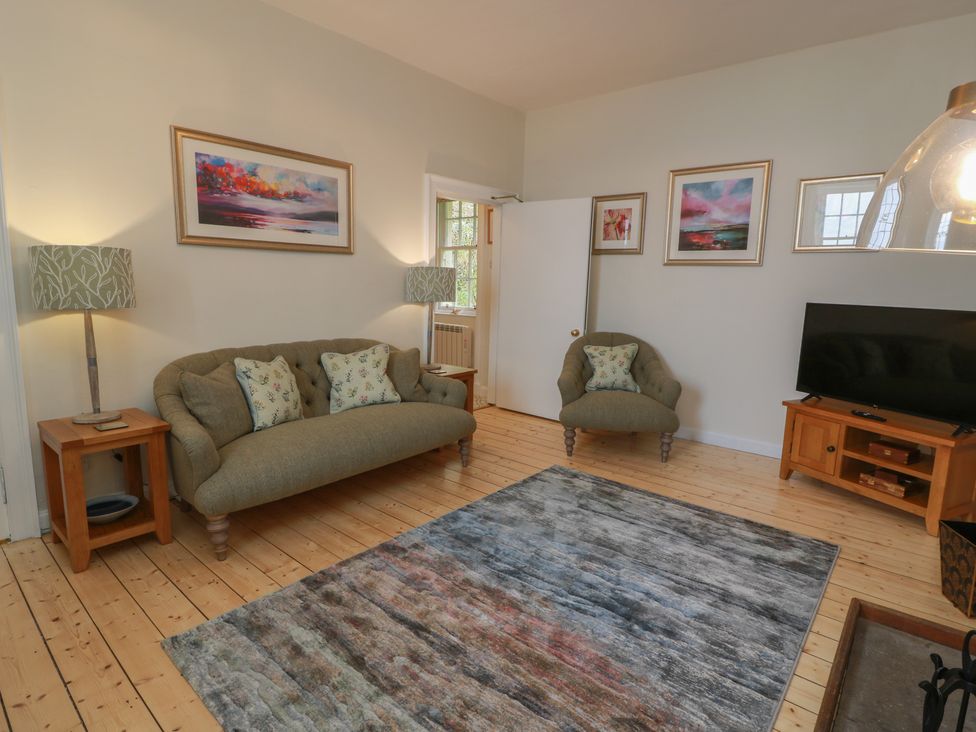A living room with a sofa and armchair at South Segganwell - Culzean Castle Maybole