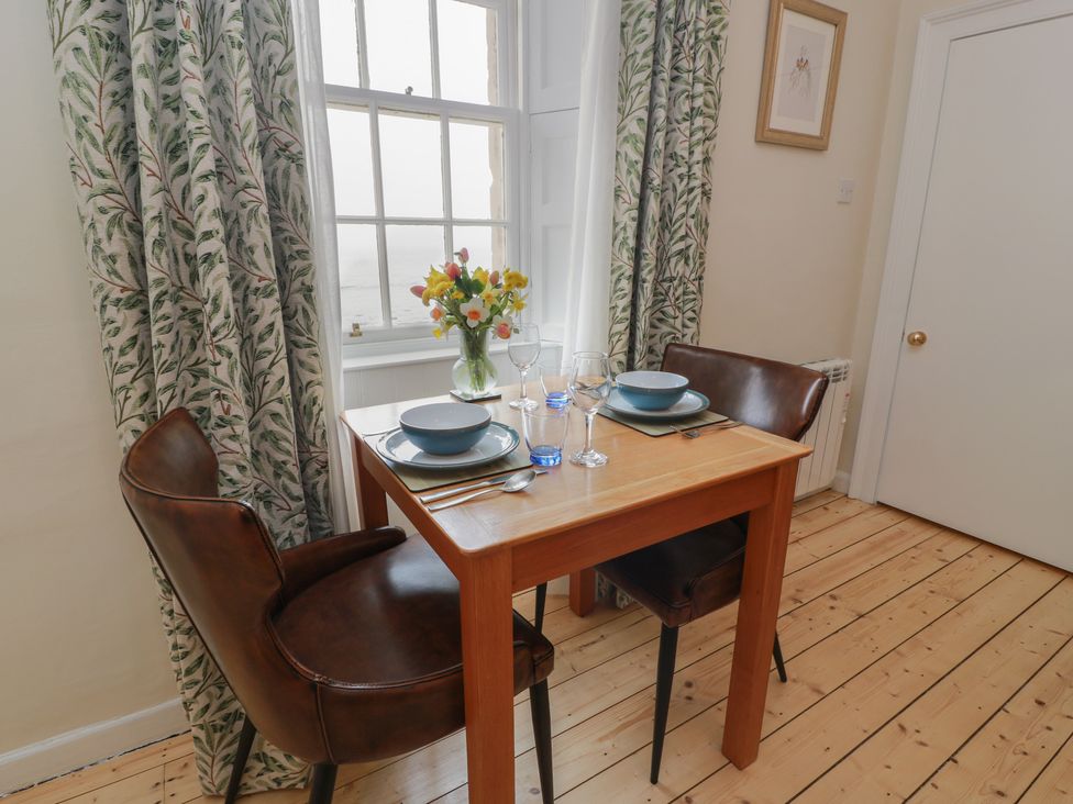 A dining room with a table set for two at South Segganwell - Culzean Castle Maybole