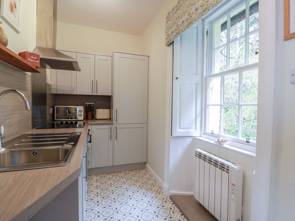 A kitchen featuring cabinets, appliances, and a window at South Segganwell - Culzean Castle in Maybole