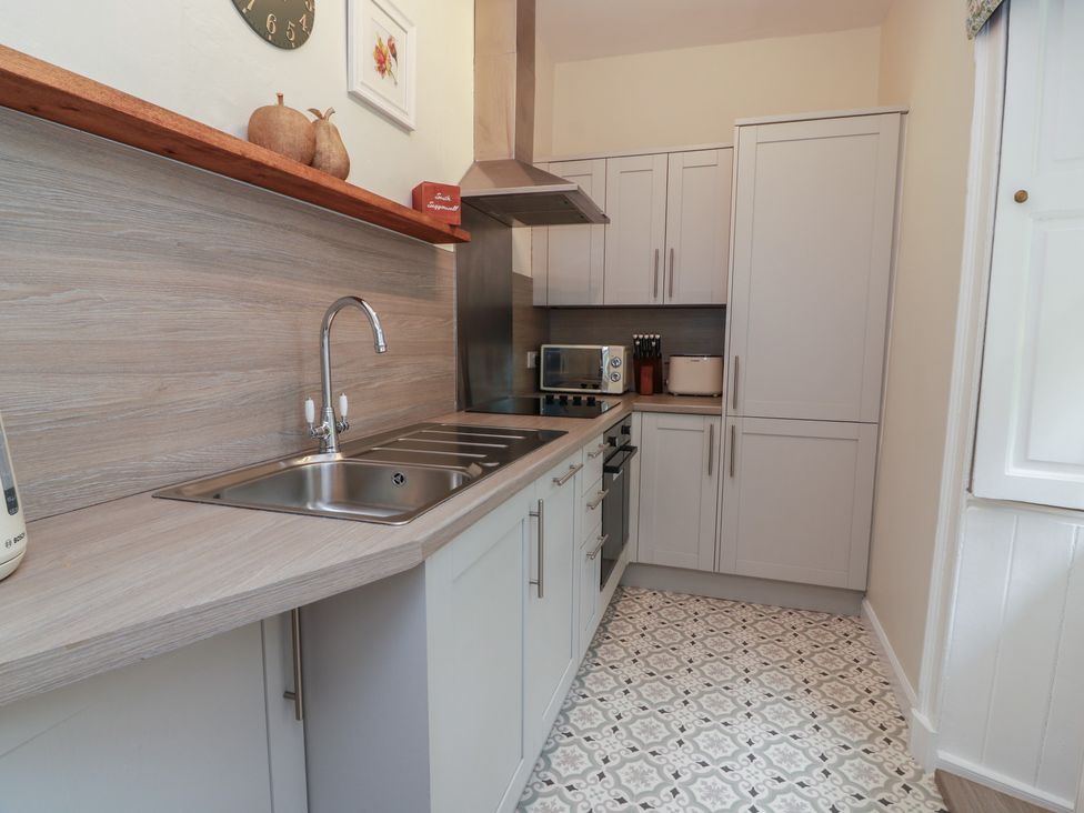 A kitchen with cabinets, sink and appliances at South Segganwell - Culzean Castle Maybole