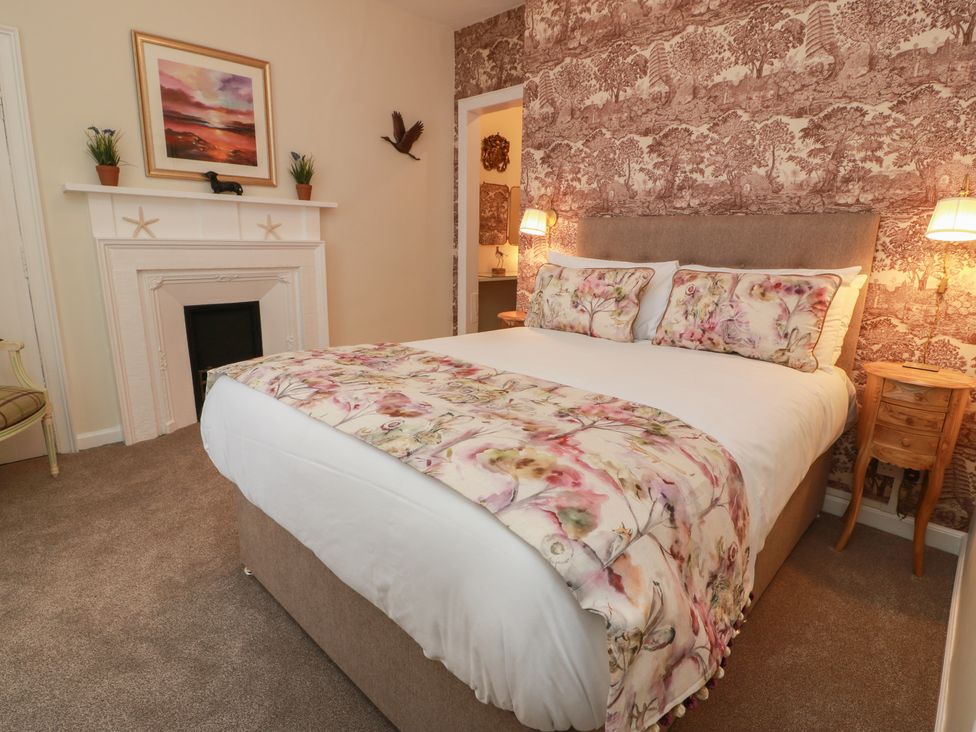 A bedroom with a bed and fireplace at South Segganwell - Culzean Castle Maybole