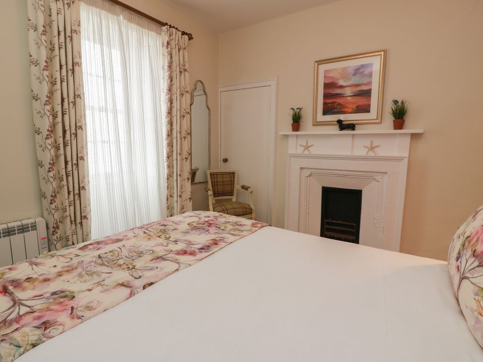 A bedroom with a bed and chair at South Segganwell - Culzean Castle in Maybole