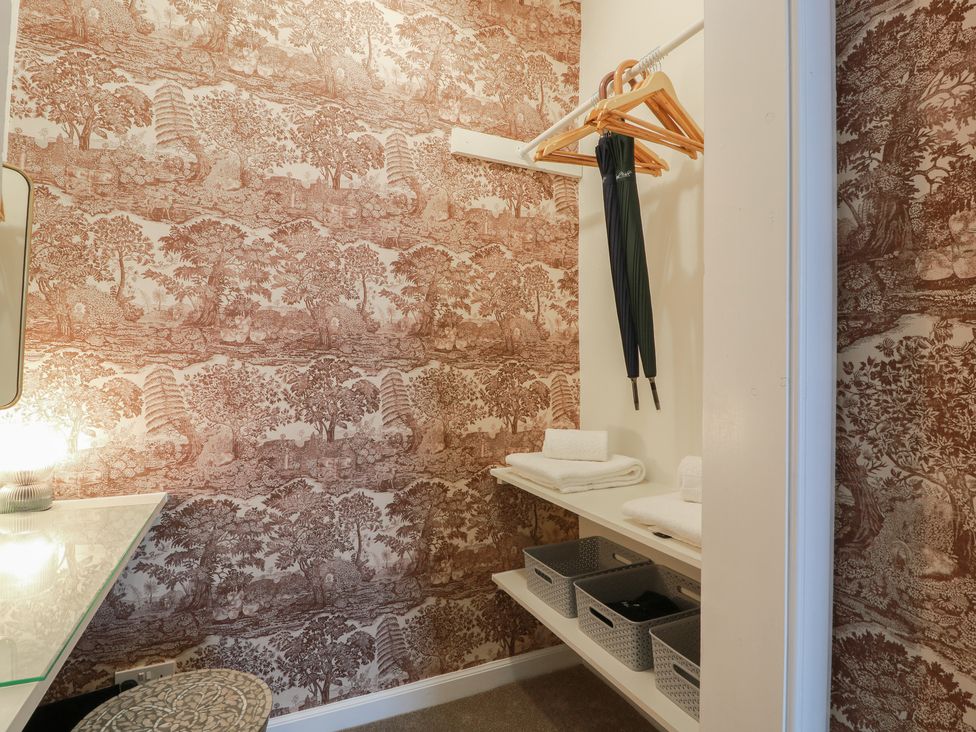A closet with shelves, a hanging area, and storage baskets at South Segganwell - Culzean Castle, Maybole