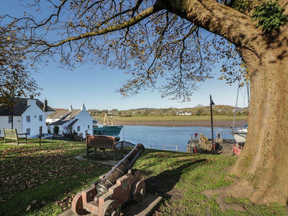 A view of boats and houses by the water at Blue Door - Kirkcudbright