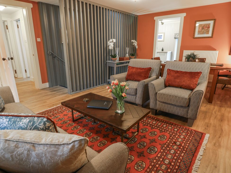 A living room with chairs and a coffee table at The Coach House - Holmwood, Glasgow