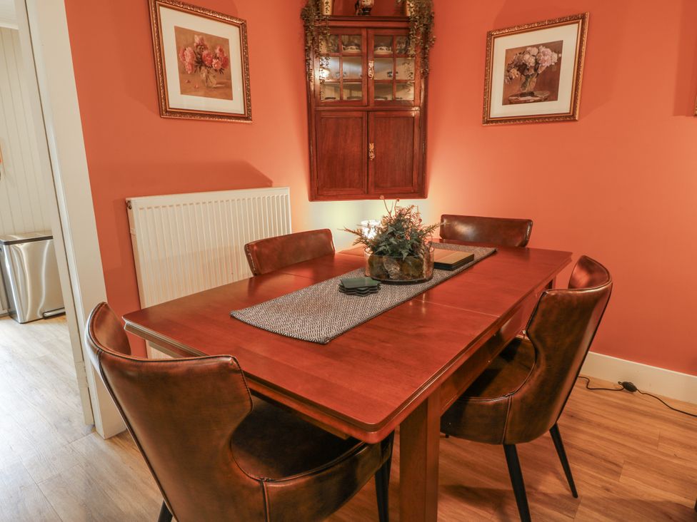 A dining room with a table and chairs at The Coach House - Holmwood in Glasgow
