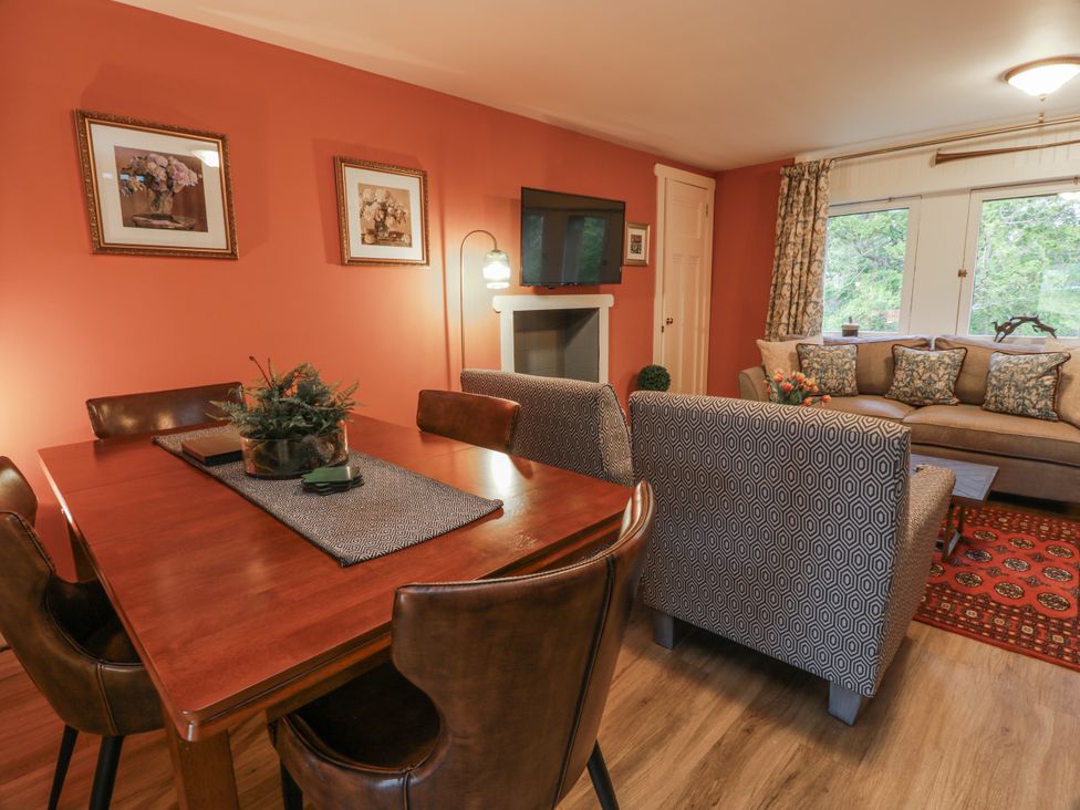 A dining room with a table and chairs at The Coach House - Holmwood in Glasgow