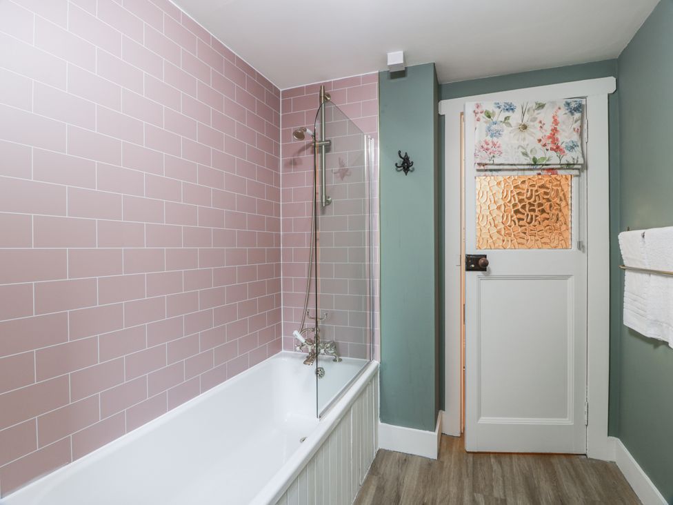 A bathroom with a bathtub and shower at The Coach House - Holmwood, Glasgow
