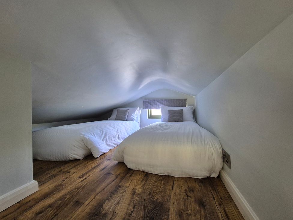 A bedroom with two beds and a window at Birch Banc Retreats - Bedw Llanidloes
