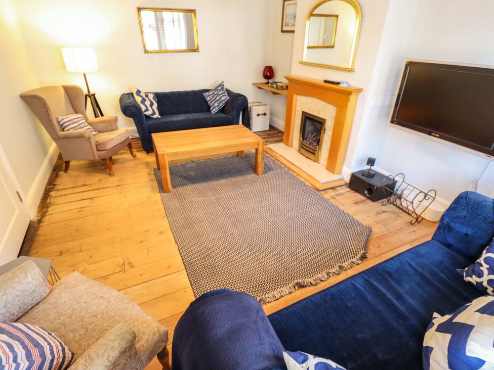 A living room with a coffee table and fireplace at Maples in Hunstanton