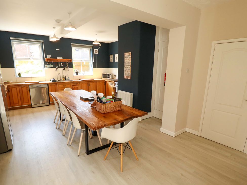 A kitchen with wooden dining table and chairs at Maples in Hunstanton