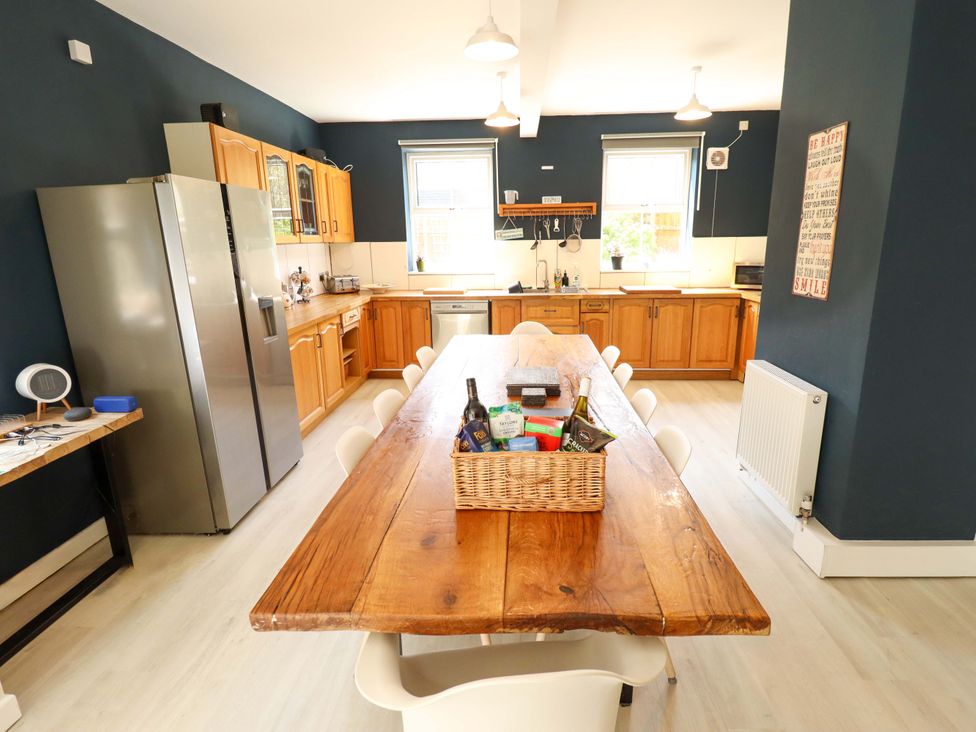 A kitchen with a wooden table and chairs at Maples in Hunstanton