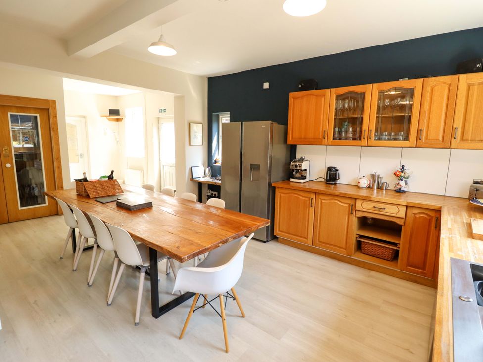 A kitchen with a dining table and chairs at Maples in Hunstanton