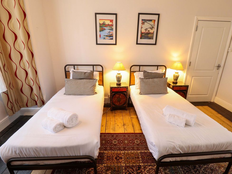 A bedroom with two single beds and decor at Maples in Hunstanton