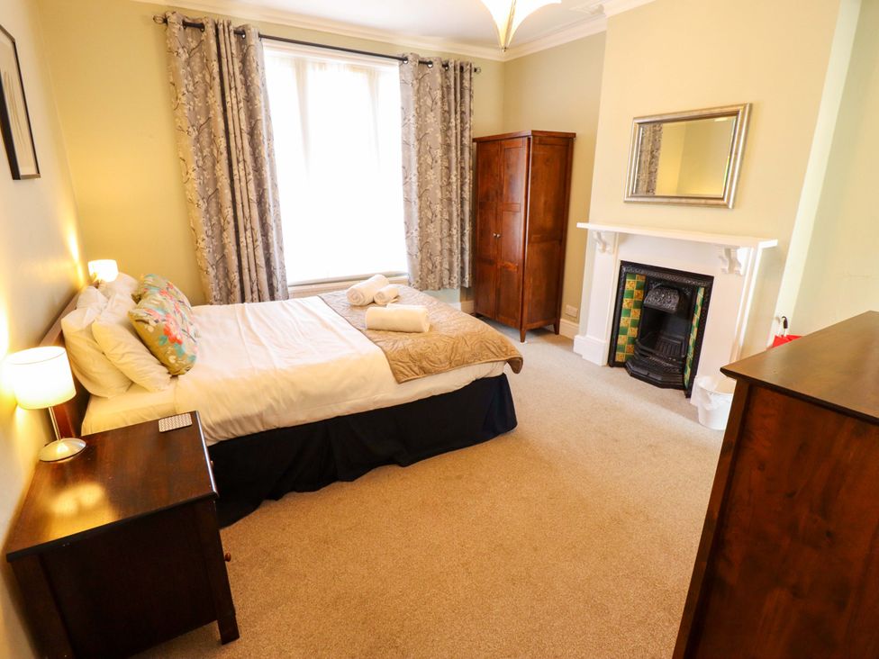 A bedroom with a bed and wardrobe at Maples in Hunstanton