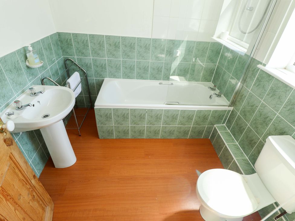 A bathroom with a sink, bathtub, and toilet at Maples in Hunstanton