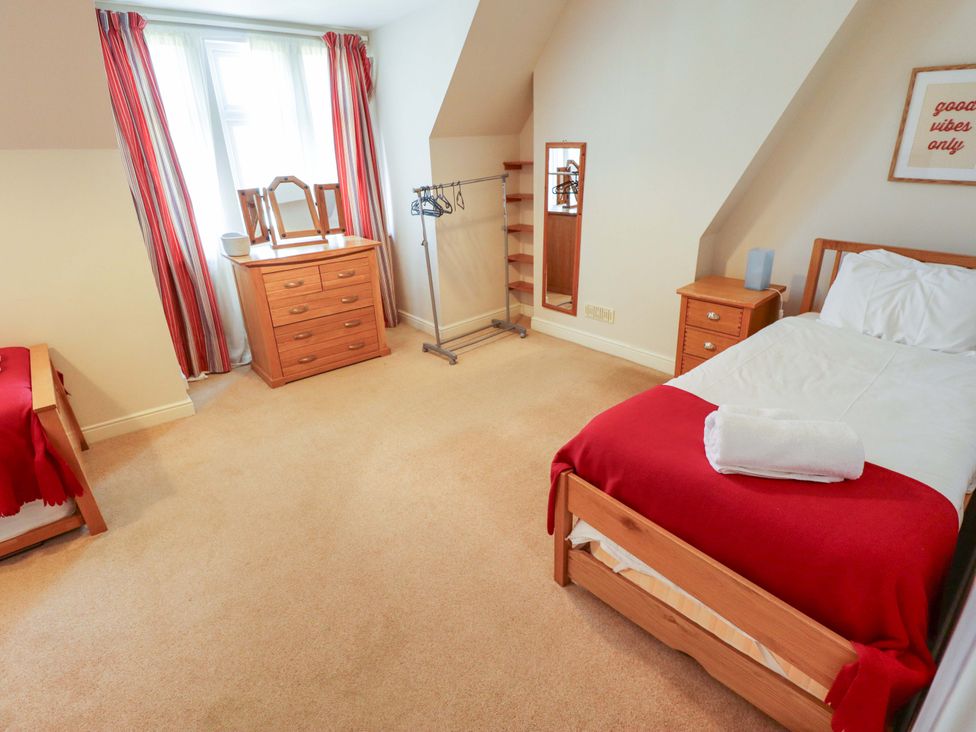 A bedroom with a bed and furniture at Maples in Hunstanton