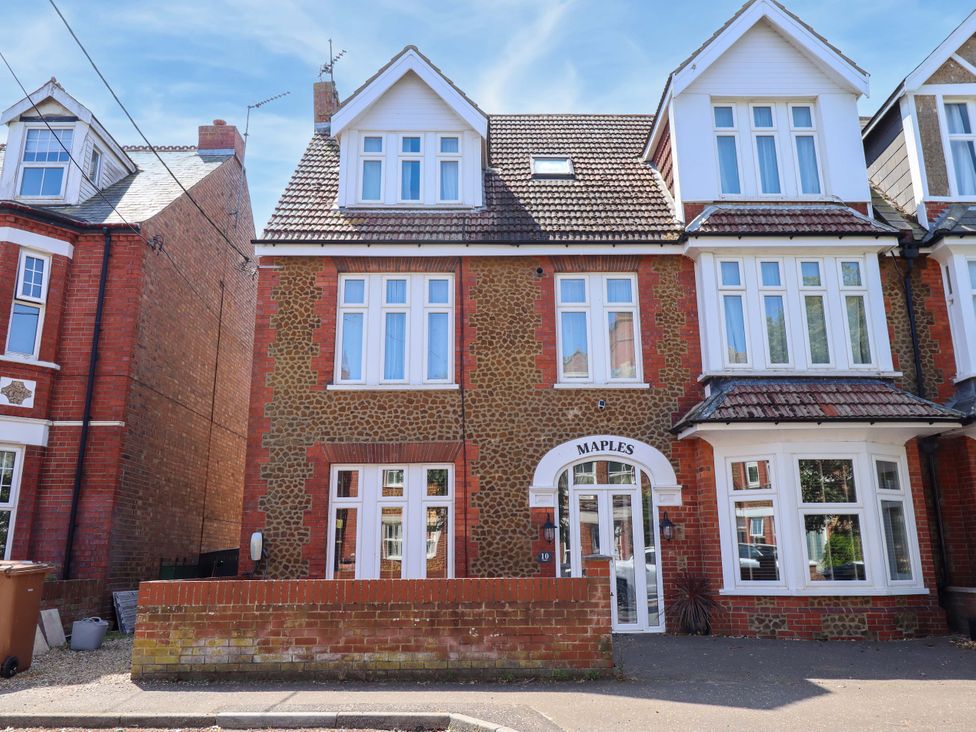 A house with multiple windows and a door at Maples in Hunstanton