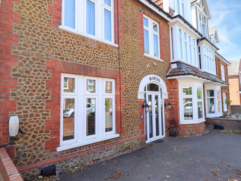 A building with stone and brick exterior at Maples in Hunstanton