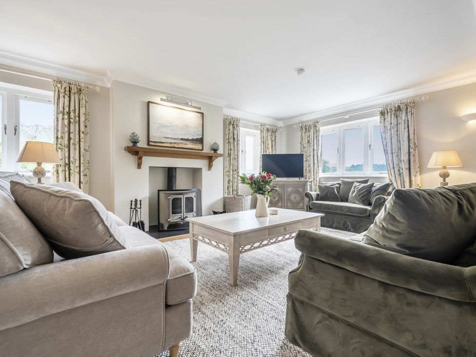 A living room with a sofa and coffee table at Cunsey Lodge at the Graythwaite Estate near Hawkshead