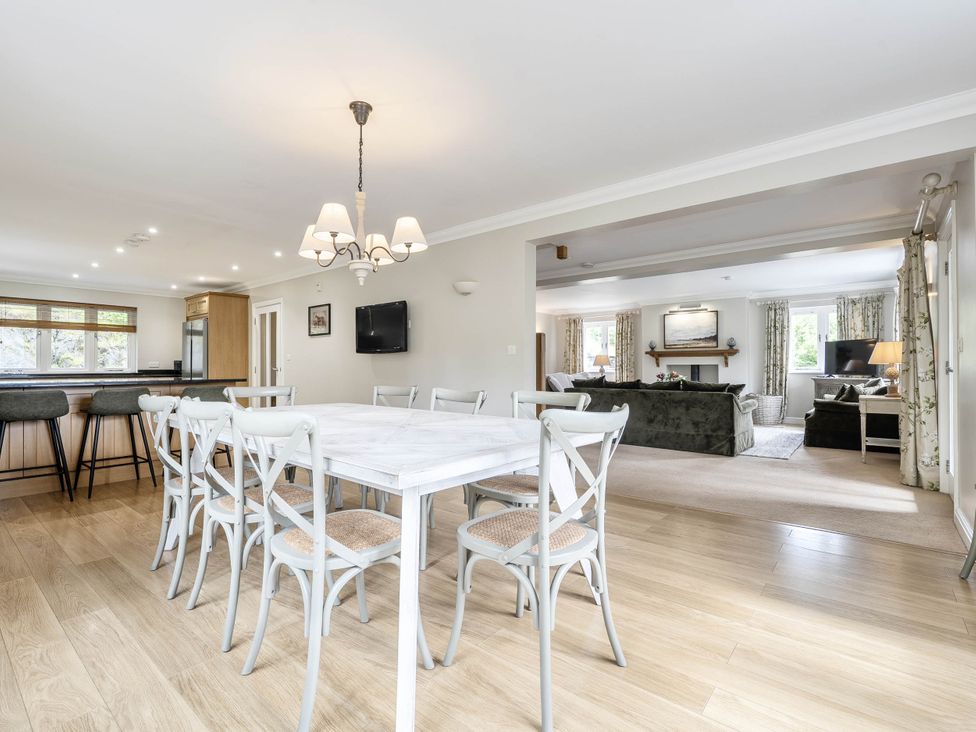 A dining room with a table and chairs at Cunsey Lodge at the Graythwaite Estate near Hawkshead