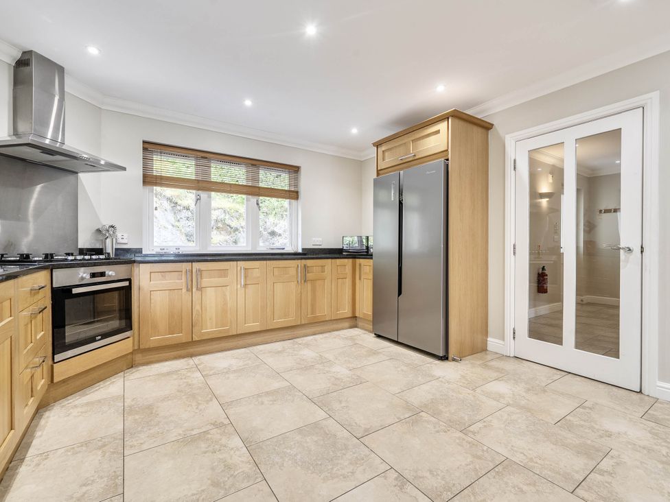 A kitchen with cabinets and appliances at Cunsey Lodge at the Graythwaite Estate near Hawkshead