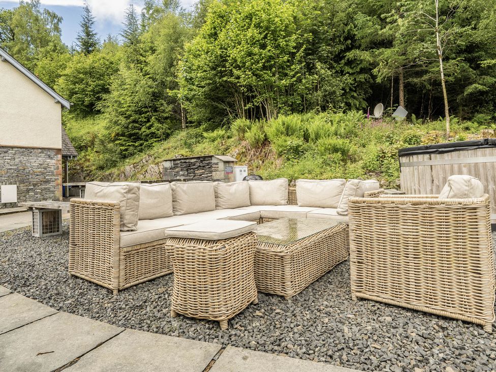 An outdoor area with a seating arrangement and a hot tub at Cunsey Lodge at the Graythwaite Estate