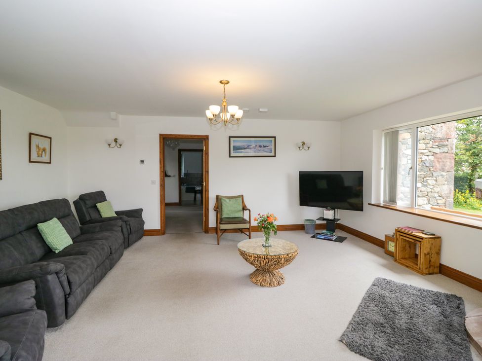A living room with a sofa and a television at Sherriff, Troutbeck, near Keswick