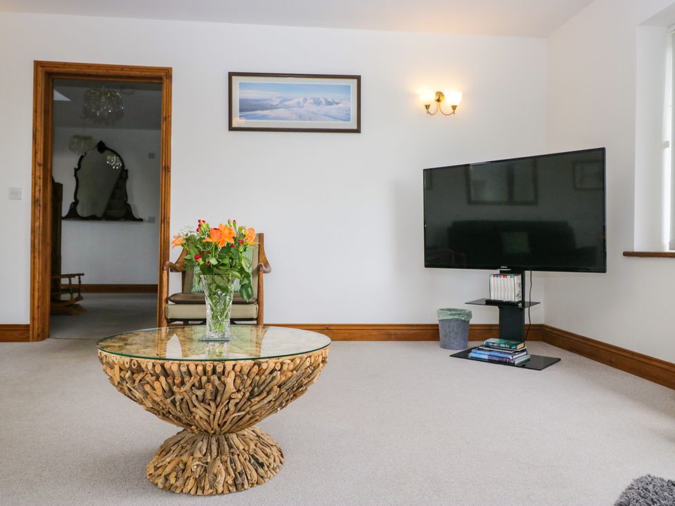 A living room with a coffee table and television at Sherriff, Troutbeck, near Keswick