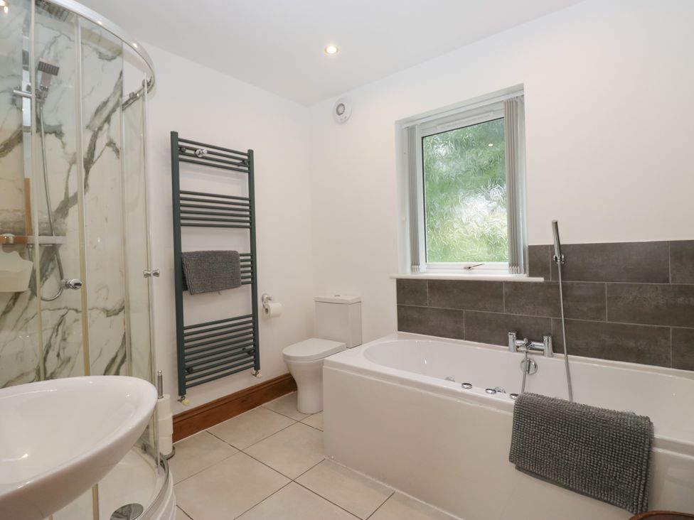 A bathroom with a shower and bathtub at Sherriff in Troutbeck, near Keswick