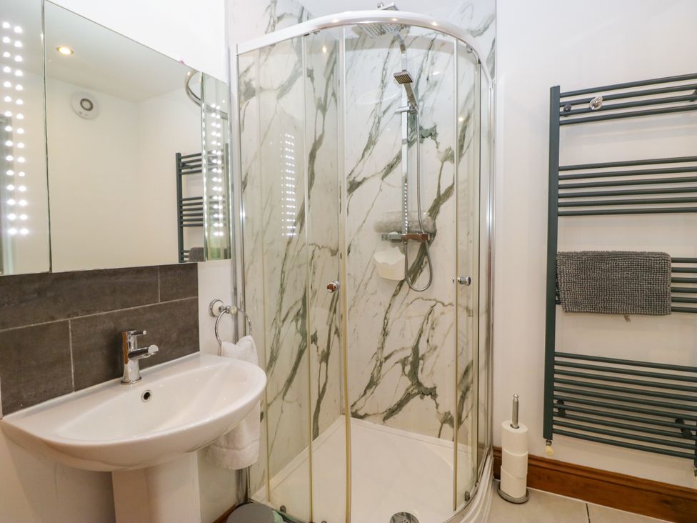 A bathroom with a shower and sink at Sherriff, Troutbeck, near Keswick